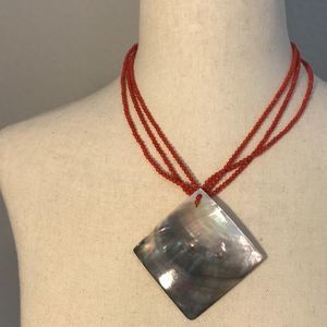 Red beaded necklace with abalone shell